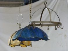Two glass lamp shades, one blue/green the other butterscotch/ivory together with a metal pan hanger,