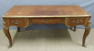 A 19th/20thC French gilt mounted leather topped desk with three drawers to one side and dummy