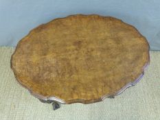 A 19thC oval inlaid walnut table raised on four turned supports,