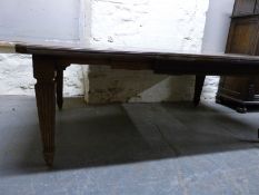 A Victorian rectangular walnut dining table on tapering fluted legs,