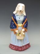 A large Staffordshire style novelty figure of a dog with puppy in a basket,