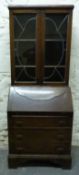 An early 20thC oak glazed bureau bookcase,