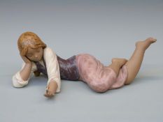 A Lladro figurine of a girl with a snail on her finger,