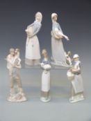 Five Lladro figures holding animals or birds,