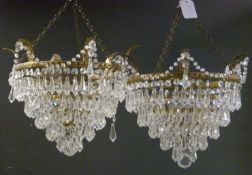 A pair of gilt metal and cut glass five tier chandeliers each 30cm in diameter.