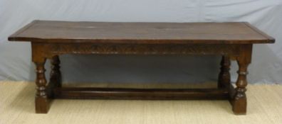 An oak three plank peg jointed refectory table raised on turned baluster supports,