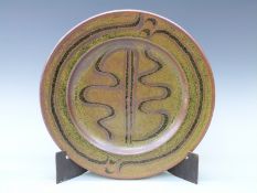 A Winchcombe studio pottery stoneware charger with hare's fur glaze and trailed decoration,