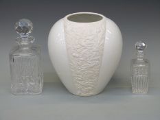 Rosenthal classic vase with relief decoration of birds amongst foliage and two cut glass decanters,