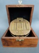 A cased natural sine compass