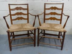 A pair of Cotswold School/Macclesfield rush seated ladder back Arts and Crafts armchairs