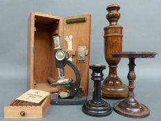 A cased microscope, cast metal stand or tazza,
