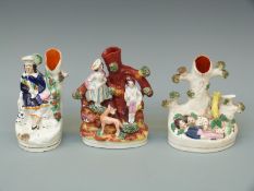 Three small 19thC Staffordshire figural spill vases including sweethearts sleeping,