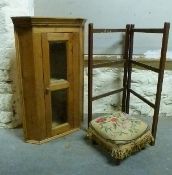 A glazed pine hanging corner cupboard with bevelled glass and a footstool,