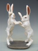 A crackle glazed pottery figure of boxing hares, impressed mark to base, possibly Bg,