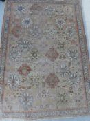 An Afghan rug with beige ground,