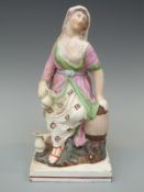 A 19thC pearlware figurine of a seated lady with jug,