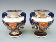 A pair of Regency porcelain inkwells and potpourri, in the form of urns with beast finials,