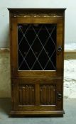 A glazed oak cabinet,
