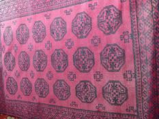 A Turkoman wool rug of red and black design,