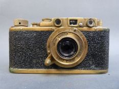 A FED or Zorki Leica copy camera, in brass finish bearing serial number 303610, in case,