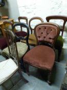 A harlequin set of Victorian mahogany balloon back chairs and an Edwardian chair