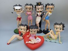 A collection of Betty Boop figures and a money box