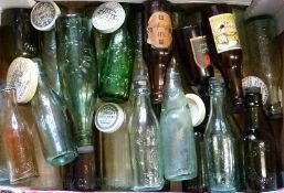 A collection of old beer bottles of Stroud interest and assorted ceramic pot lids