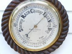 Negretti & Zambra of London barometer in oak rope twist surround,