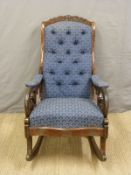 Victorian mahogany rocking chair with blue upholstered seat and pierced scroll arms