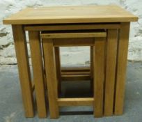 A modern light oak nest of tables,