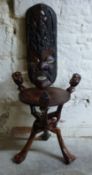 A carved African mask and figural table,