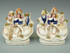 A pair of 19thC Staffordshire figures with swans,