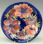 Moorcroft charger in the Anemone pattern on blue ground, signed and impressed verso,