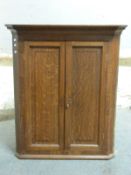 A Georgian oak hanging corner cupboard,