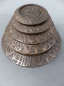 A set of A K & Sons cast iron flat stacking weights 4lb downwards