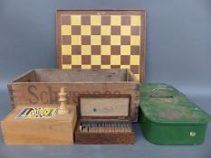 A wooden Schweppes advertising crate containing wooden chess set, bakelite draughts,