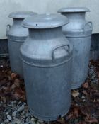 Three vintage lidded milk churns with inscriptions for Horlicks Unigate,