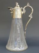 A cut and line engraved clear glass claret jug with silver plated handle and fittings decorated