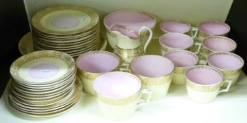 A Victorian Staffordshire part tea set, the pale yellow and pink ground with gilt decoration,