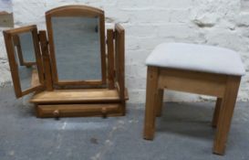 A pine dressing table mirror with bevelled glass and single drawer and an upholstered stool,