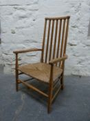 A Cotswold School Arts and Crafts ash armchair with rush seat,