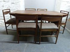 A retro G Plan style extending table and six upholstered chairs,