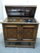 A retro carved oak wind up gramophone and radiogram with bakelite pick up and fittings,