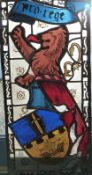 A mid-20thC stained glass window depicting rampant lion, shield and 'pro-rege', 31cm x 63cm,