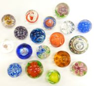 Eighteen various decorative glass paperweights,