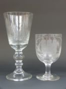 Two large clear glass wine glasses both engraved with ships one HMS Victory, largest 20cm tall.