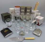 A collection of whisky related glassware including tumblers in named single malt branded canisters