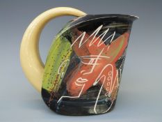 A studio pottery slipware jug with incised figural decoration of saxophone player,