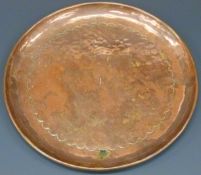 Newlyn hammered copper plate with incised border, stamped 'Newlyn' to the centre, 20cm in diameter.