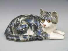 A large Mike Hinton for Winstanley tabby cat lying down, length 32cm,